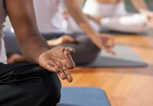 meditating hands in yoga class