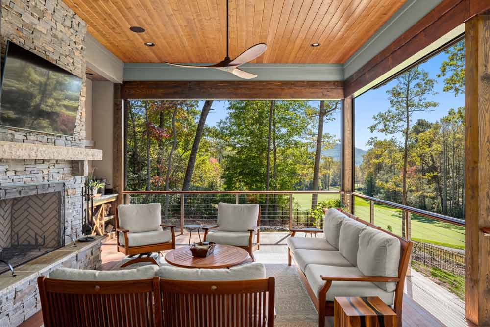 sitting room with fireplace overlooking forest