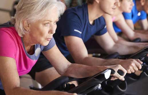 Senior taking spinning class